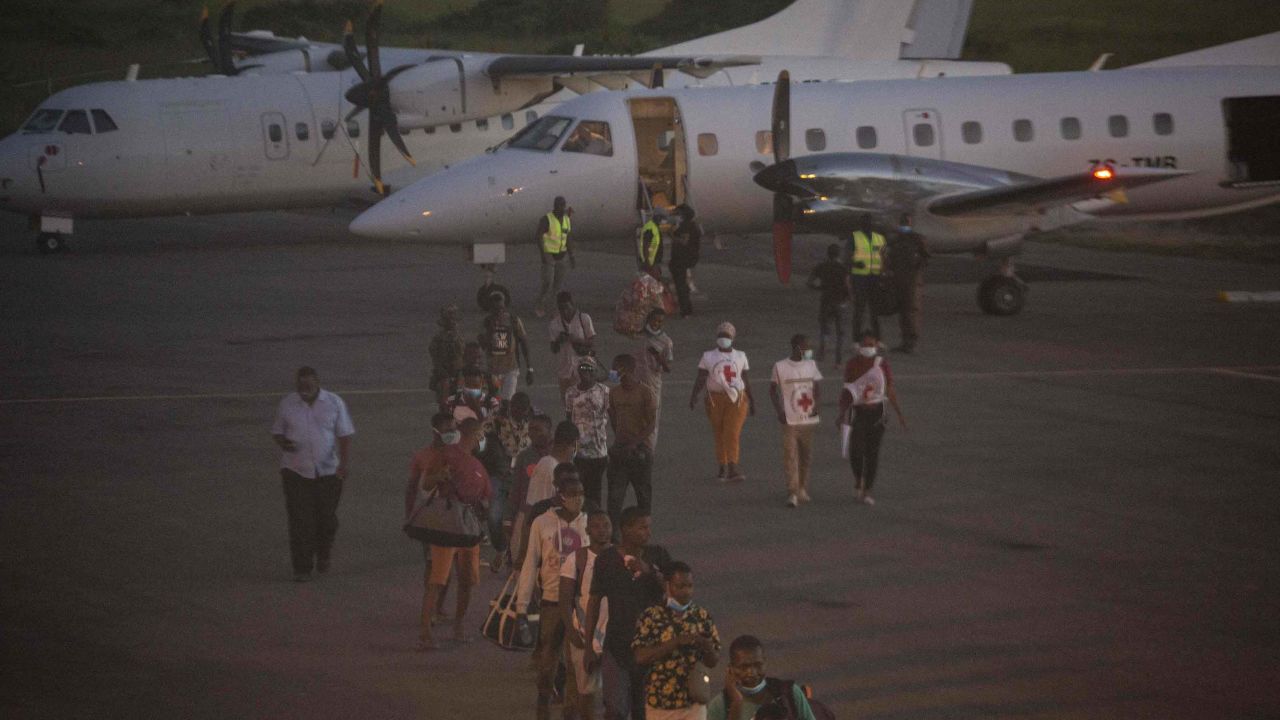 People evacuated from Palma arrive on an humanitarian flight at the airport in Pemba on March 31.