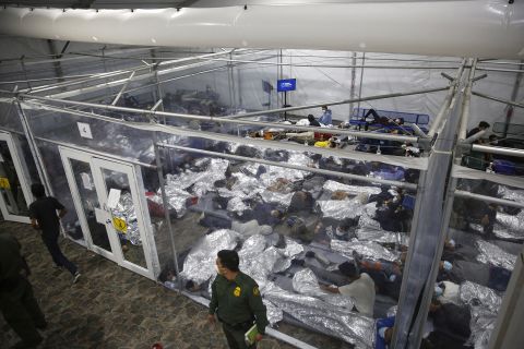 Migrant children lie inside a pod at a federal holding facility in Donna, Texas, on Tuesday, March 30. The Biden administration allowed a few members of the media <a href="https://www.cnn.com/2021/03/30/politics/overcrowded-border-facility-donna-texas/index.html" target="_blank">to tour the temporary facility,</a> which is well over capacity. Of the 4,100 migrants at the facility, 3,400 were unaccompanied children.
