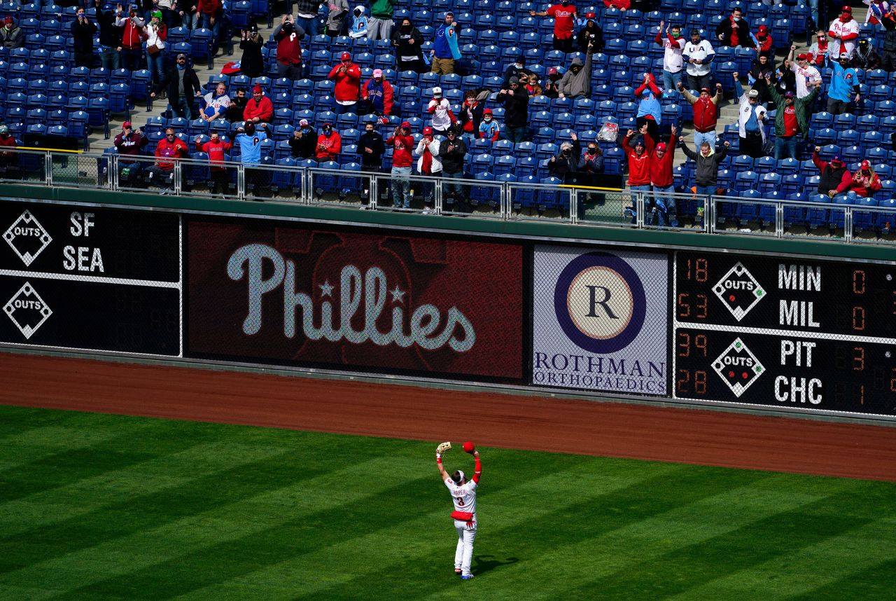 Baseball star Bryce Harper waves to fans before the start of the Philadelphia Phillies' Opening Day game against Atlanta on Thursday, April 1. The majority of Major League Baseball teams are opening their seasons with stadiums at 20% to 30% capacity, allowing fans to socially distance from one another. <a href="http://www.cnn.com/2021/04/01/us/gallery/opening-day-baseball-2021/index.html" target="_blank">See the best photos from Opening Day</a>