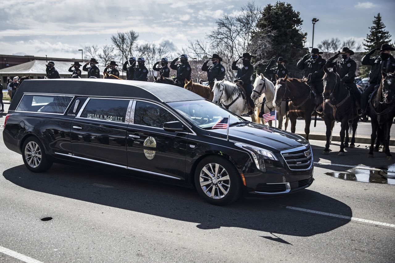 Law enforcement officers salute a hearse carrying Eric Talley to <a href="https://www.cnn.com/2021/03/30/us/officer-eric-talley-funeral-colorado/index.html" target="_blank">his memorial service</a> in Lafayette, Colorado, on Tuesday, March 30. Talley, a member of the Boulder Police Department in Colorado, was one of 10 people killed in a mass shooting last week at a Boulder grocery store. He was 51 years old.
