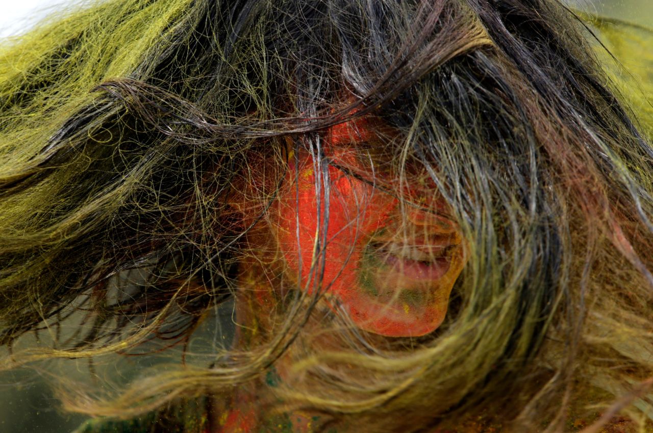 A woman dances during Holi celebrations in Mumbai, India, on Monday, March 29. The Holi festival of colors is a Hindu celebration marking the arrival of spring.