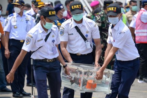 Officials in Jakarta, Indonesia, carry a box containing the <a href="https://www.cnn.com/2021/01/09/asia/indonesia-sriwijaya-air-plane-intl/index.html" target="_blank">cockpit voice recorder</a> of Sriwijaya Air Flight 182 on Wednesday, March 31. The passenger plane crashed in January with 62 people on board.