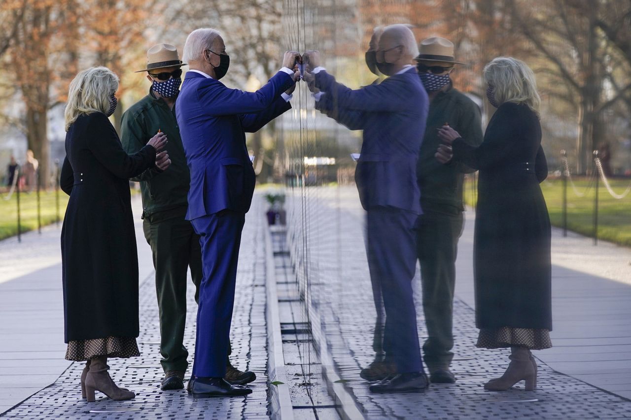 US President Joe Biden makes a tracing of Cpl. Dennis F. Shine's name after he and first lady Jill Biden laid flowers at the Vietnam Veterans Memorial on Monday, March 29. It was National Vietnam War Veterans Day. It wasn't immediately clear why the President chose Shine's name to trace.