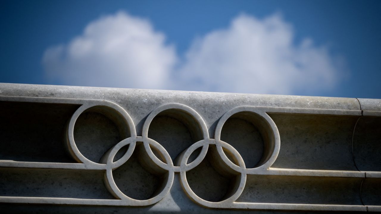 A picture taken on March 8, 2021 in Lausanne shows the Olympic rings next to the headquarters of the IOC.