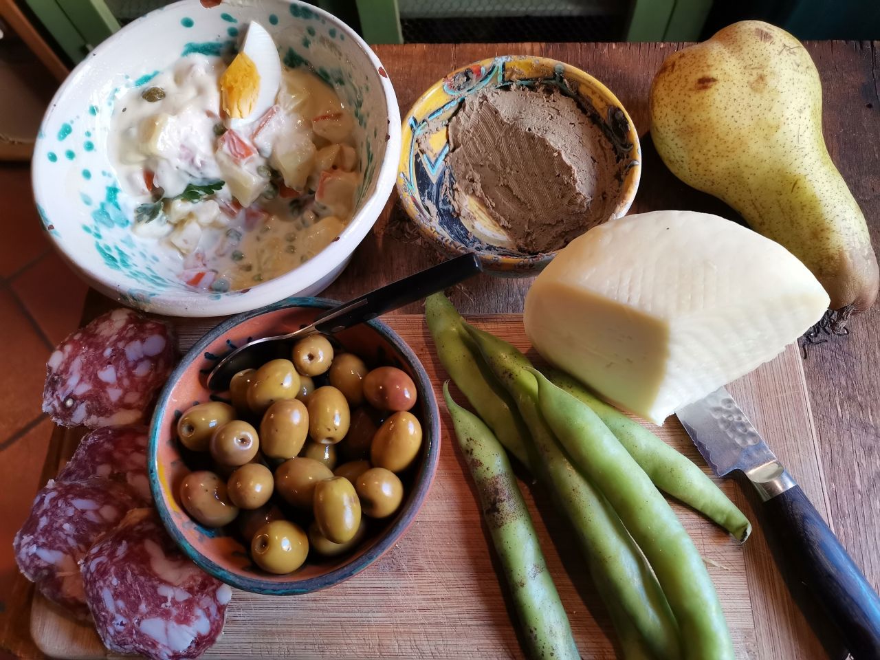 Easter in Italy is celebrated on Sunday and Monday. The Monday celebration, called Pasquetta, is often an outdoor picnic. This picnic spread includes salami, olives, insalata russa, fava beans and pecorino Romano.