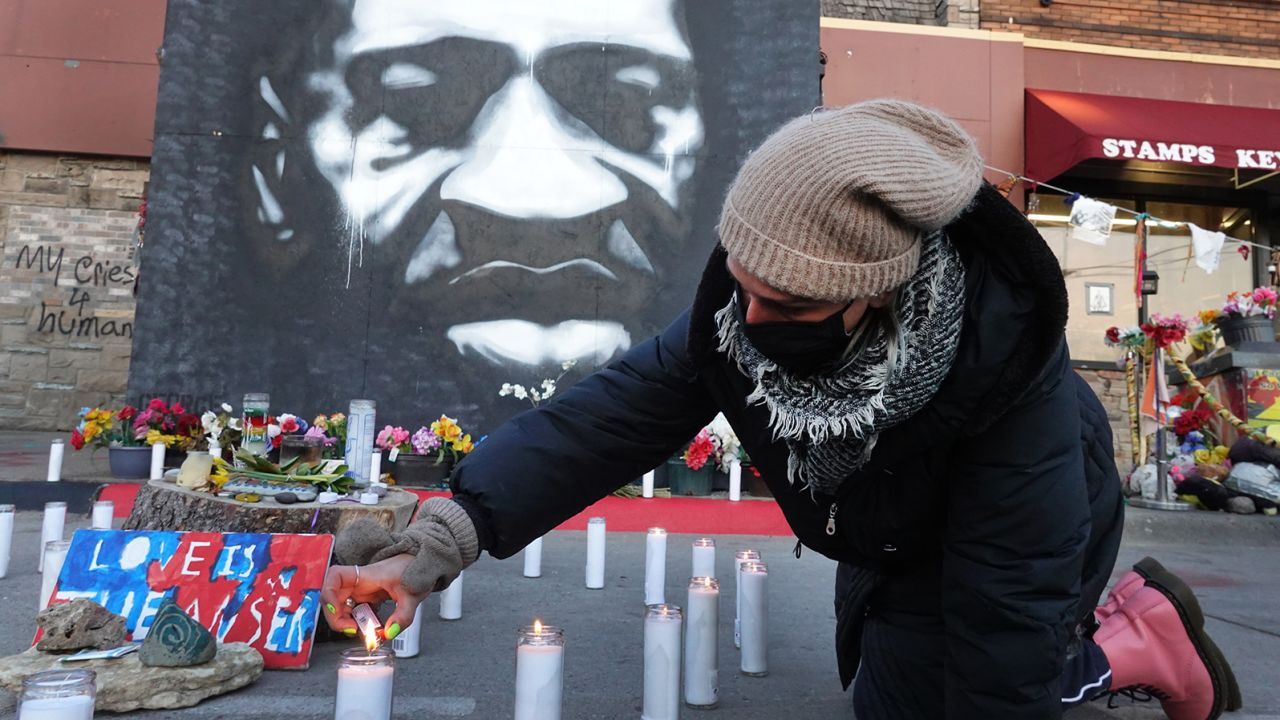 MINNEAPOLIS, MINNESOTA - MARCH 28: Community activists light candles at a memorial near the site where George Floyd died at the hands of former Minneapolis police officer Derek Chauvin on March 28, 2021 in Minneapolis, Minnesota. The trial for Chauvin, who is accused of murder in Floyd's death, begins tomorrow. Security is heightened in the city in an effort to prevent a repeat of rioting that occurred in Minneapolis and major cities around the world following Floyd's death on May 25, 2020.  (Photo by Scott Olson/Getty Images)