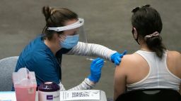 A healthcare worker administers a dose of the Pfizer-BioNTech Covid-19 vaccine inside the Viejas Arena on the campus of San Diego State University in San Diego, California, U.S. on Thursday, April 1, 2021. Starting April 1, Californians ages 50 and older are eligible to get the Covid-19 vaccine. Photographer: Bing Guan/Bloomberg via Getty Images
