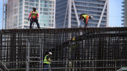 Construction workers build the "Signature Bridge," replacing and improving a busy highway intersection at I-95 and I-395 on March 17, 2021 in Miami, Florida. The Florida Department of Transportation is building the project in partnership with the Miami-Dade Expressway Authority and its contractor, the Archer Western-de Moya Group Joint Venture. The infrastructure project will ease traffic congestion, connect communities with downtown neighborhoods, and provide an iconic bridge for Miami's skyline. The entire project is scheduled for completion in the fall of 2024 at the cost of $818 million. (Photo by Joe Raedle/Getty Images)