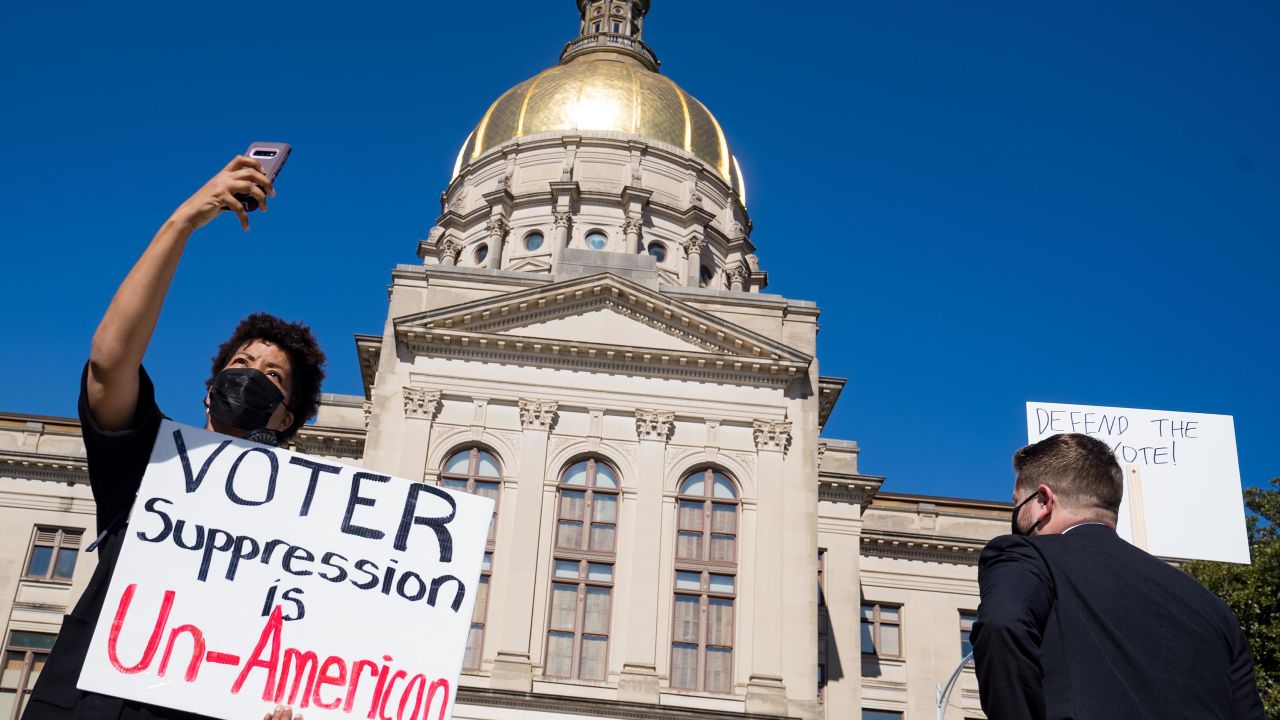 Demonstrators stand outside of the Capitol building in opposition to House Bill 531 on March 8 in Atlanta, Georgia. 