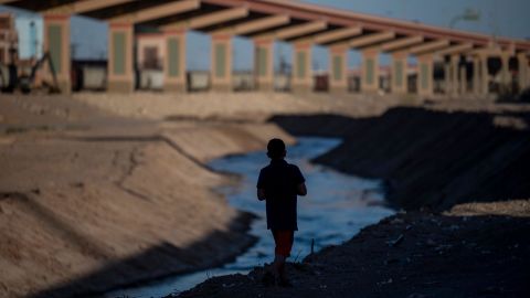 A boy walks along the Rio Bravo across the border from El Paso, Texas on March 22, 2021. 