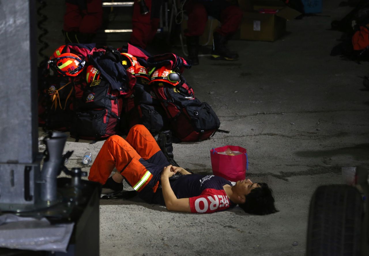A member of the emergency crews rests near the site of the derailed train.