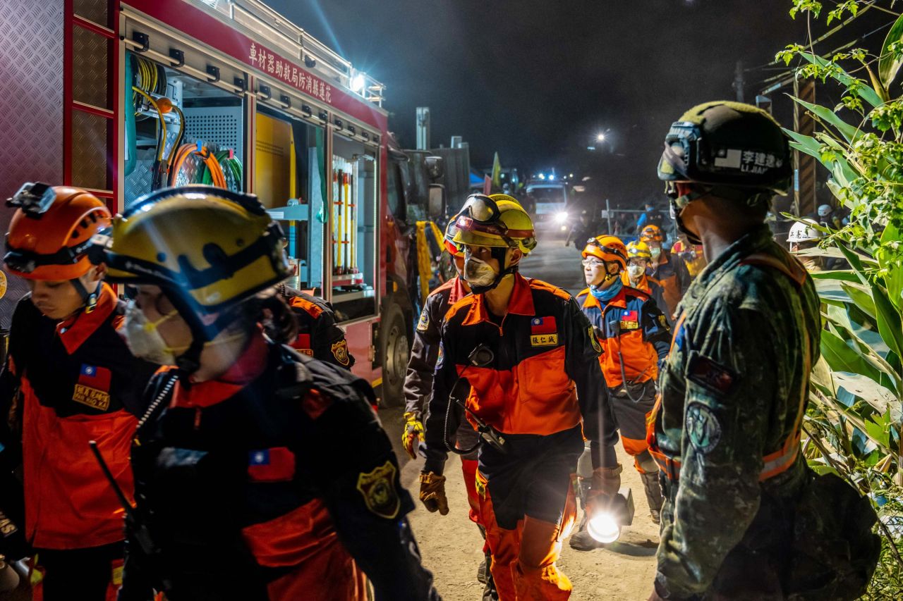 Emergency personnel gather near the tunnel on Friday.