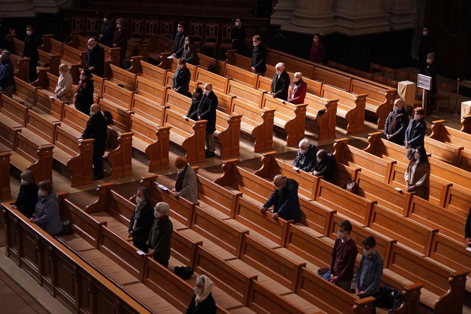 People wear face masks and observe social distancing as they attend a Good Friday church service in Berlin on April 2.