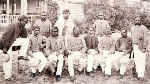 A photo of the all-Aboriginal cricket team at the Melbourne Cricket Ground in 1866, with coach Tom Wills at the back in the center and Johnny Mullagh standing to his right. Yanggendyinanyuk is on the far right.