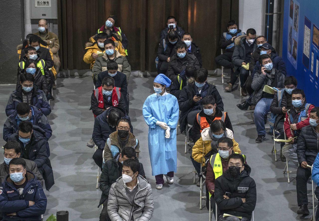 Chinese workers wait to receive a Covid-19 vaccine at a mass vaccination center in Beijing on January 15.