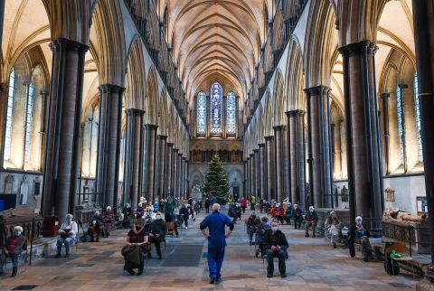 People wait to receive a Covid-19 vaccine January 20 at a vaccination center set up inside Salisbury Cathedral in Salisbury, England.