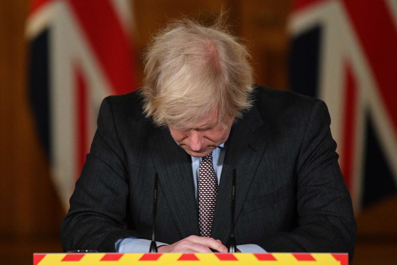 British Prime Minister Boris Johnson reacts during a Covid-19 news conference on January 26. <a href="index.php?page=&url=https%3A%2F%2Fwww.cnn.com%2F2021%2F01%2F26%2Fuk%2Fuk-covid-19-pandemic-response-intl-gbr%2Findex.html" target="_blank">The virus at that point had killed 100,000 people in the United Kingdom.</a>