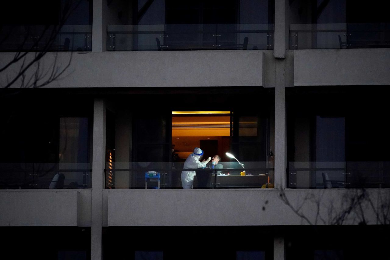 Peter Ben Embarek, a member of the World Health Organization team tasked with investigating the origins of Covid-19, receives a swab test on the balcony of a hotel in Wuhan, China, on February 3.