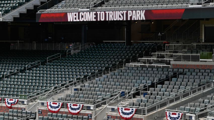 The stands at Truist Park are empty as the national anthem plays before an exhibition baseball game against the Miami Marlins, Wednesday, July 22, 2020, in Atlanta. (AP Photo/John Amis)