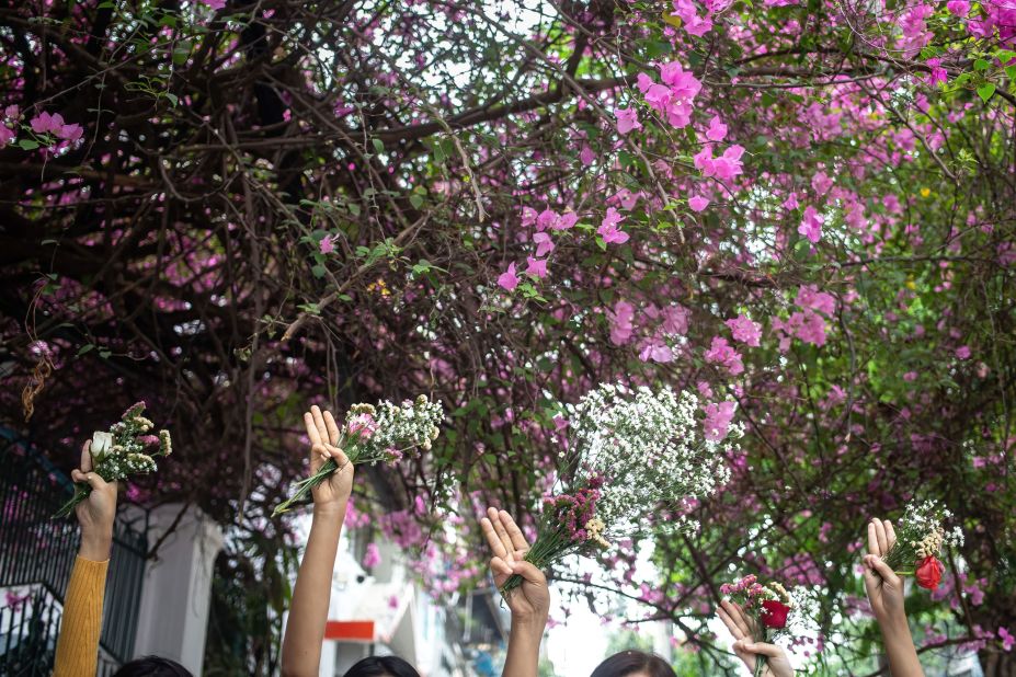 People take part in a "flower strike" in Yangon on April 2.