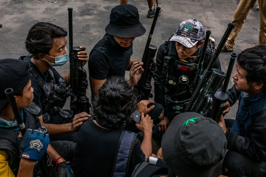 Protesters hold improvised weapons in Yangon on April 3.