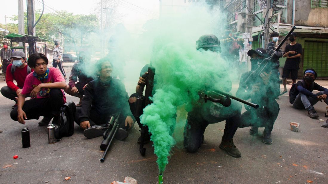 Protesters hold homemade pipe air guns during a demonstration in Yangon on April 3.