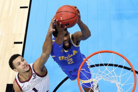 UCLA's Cody Riley is blocked by Suggs in the closing minutes of the second half.