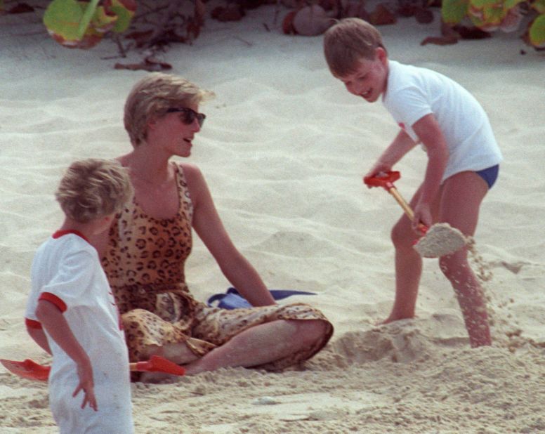 William shovels sand onto his mother while playing on a beach in 1990.