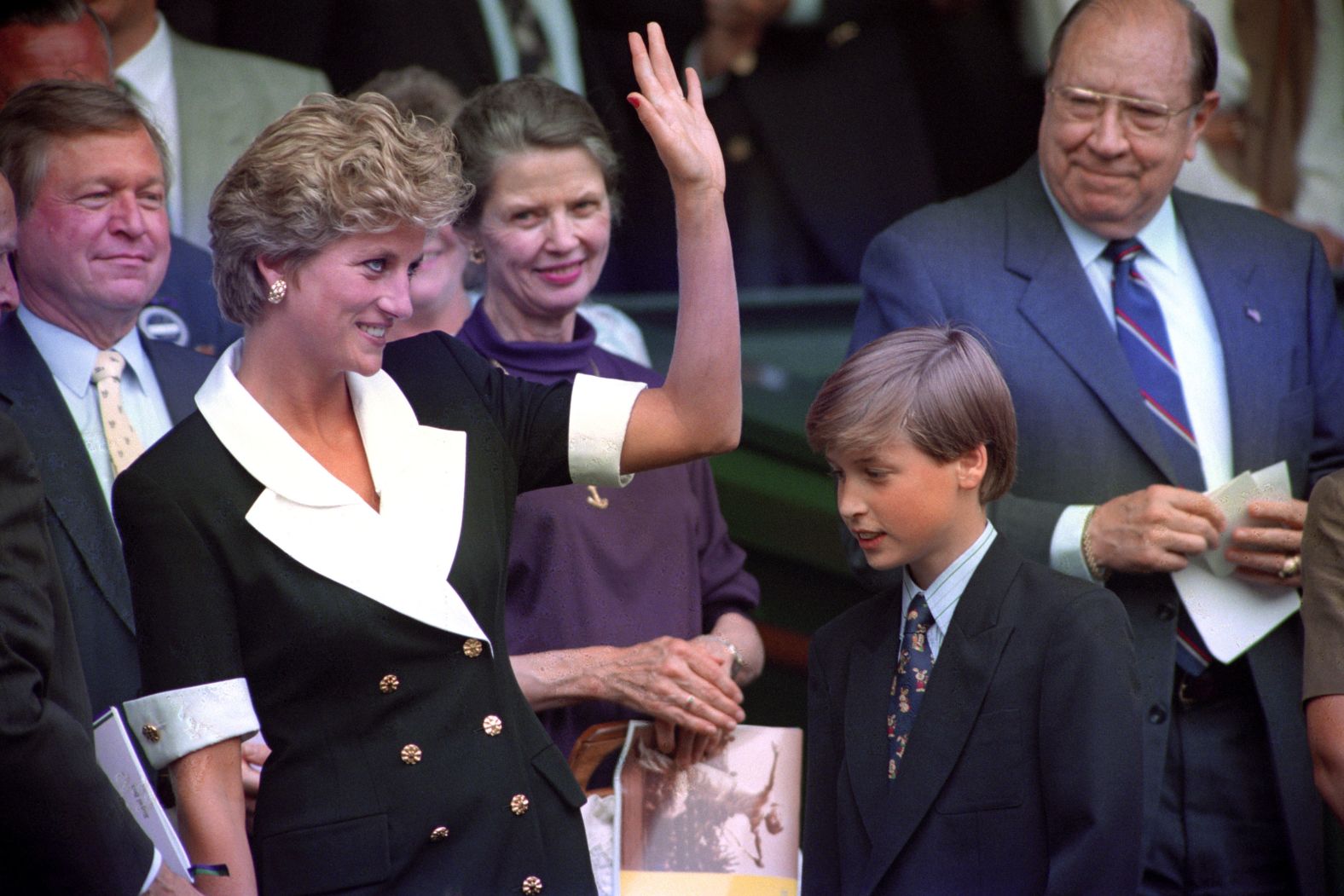 Prince William accompanies his mother to a tennis match at Wimbledon in 1994.