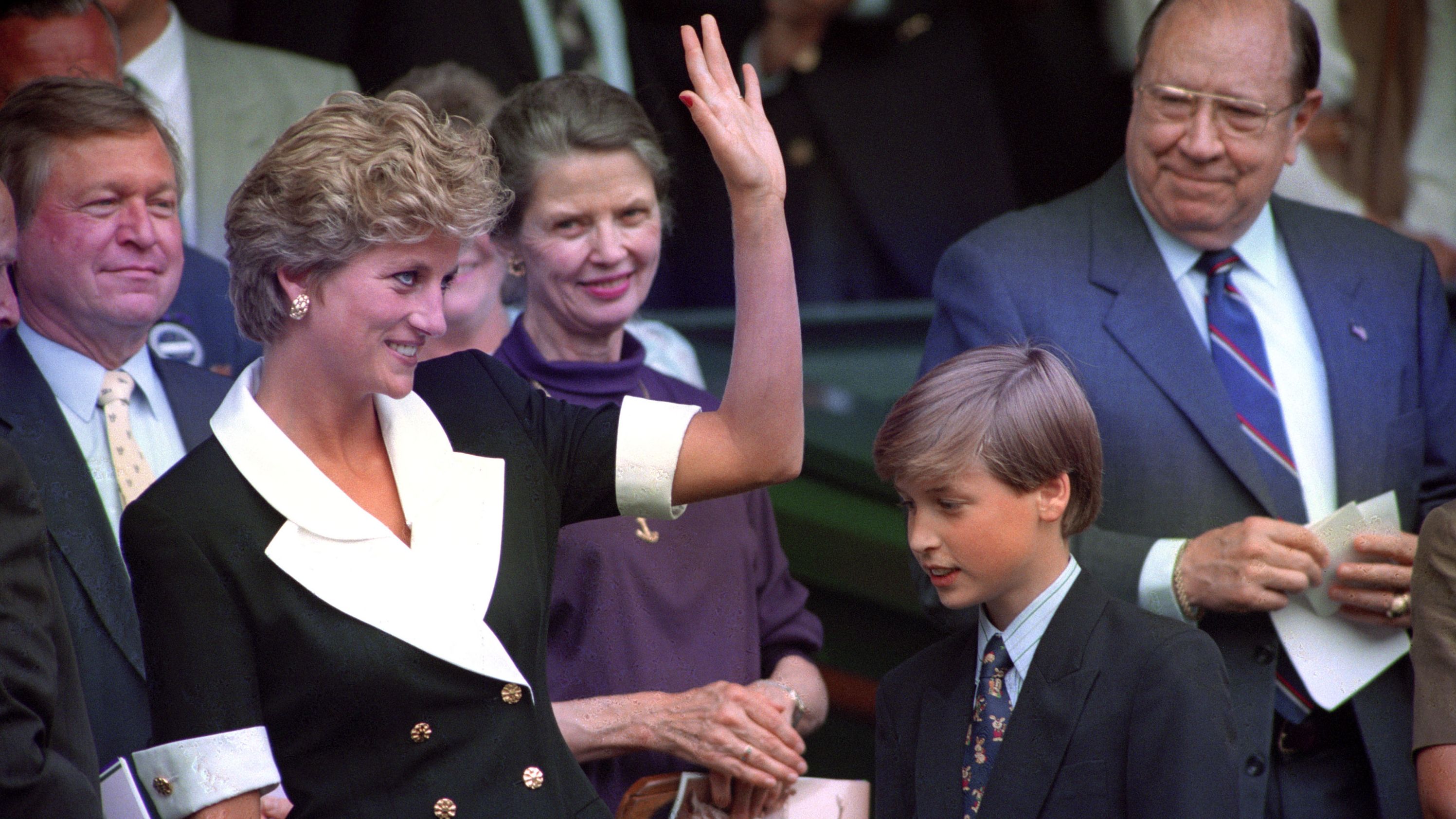 Prince William accompanies his mother to a tennis match at Wimbledon in 1994.