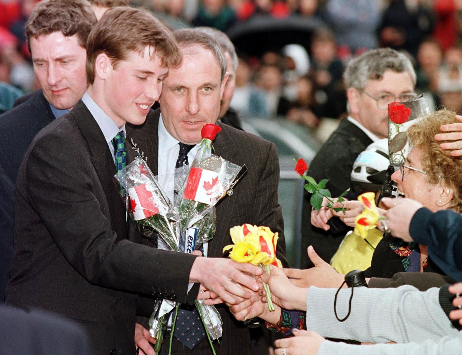 Prince William receives flowers from an adoring crowd in Vancouver, British Columbia, in 1998. He was on a weeklong vacation with his father and brother, though they also made time for official engagements.