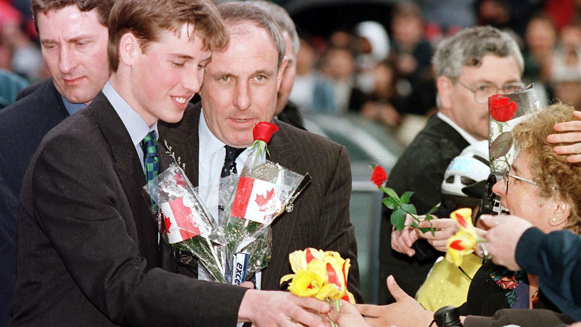 Prince William receives flowers from an adoring crowd in Vancouver, British Columbia, in 1998. He was on a weeklong vacation with his father and brother, though they also made time for official engagements.