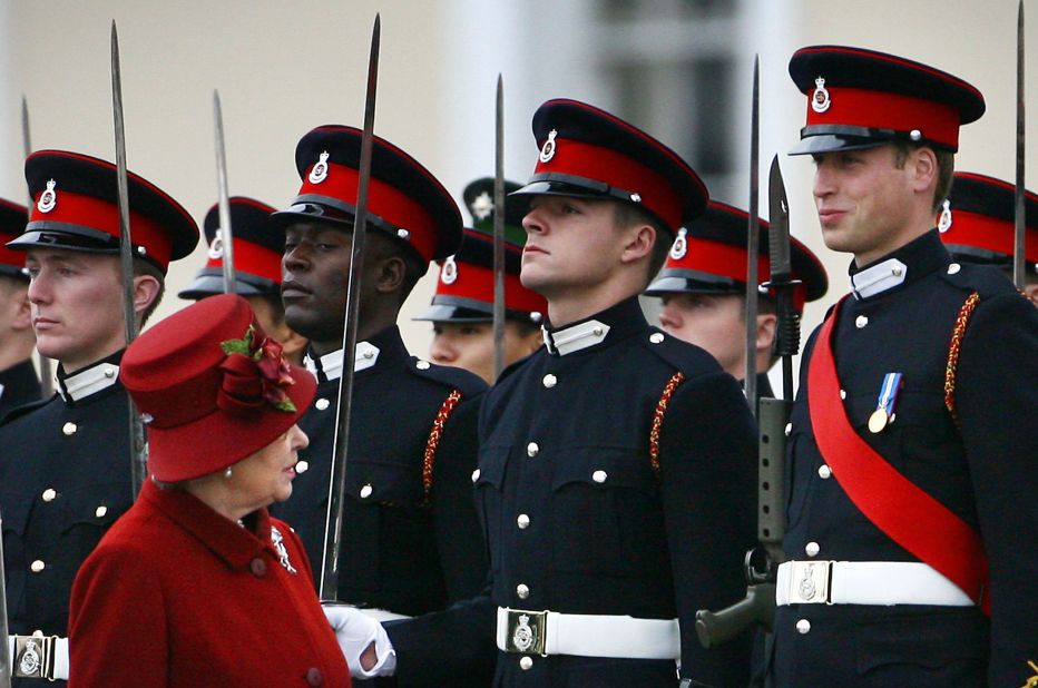 Queen Elizabeth II glances up at William, right, as she inspects the parade at the Royal Military Academy in 2006. William graduated as an Army officer and later went on to receive his Royal Air Force pilot's wings.