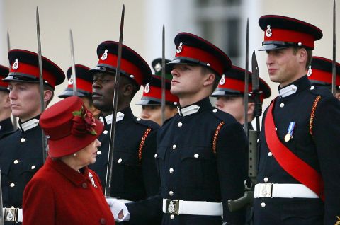 Queen Elizabeth glances up at her grandson, right, as she inspects the parade at the Royal Military Academy in 2006. Prince William graduated as an Army officer and later went on to receive his Royal Air Force pilot's wings