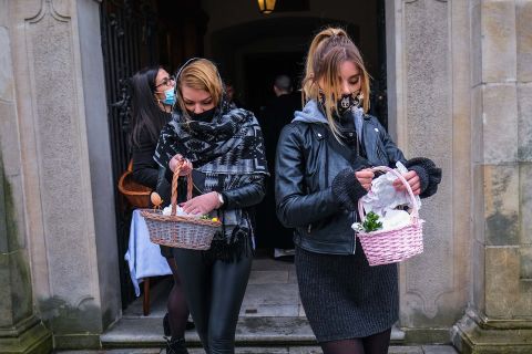 Women in Krakow, Poland, carry Easter baskets after a food-blessing ceremony at the Basilica of St. Michael the Archangel on April 3.