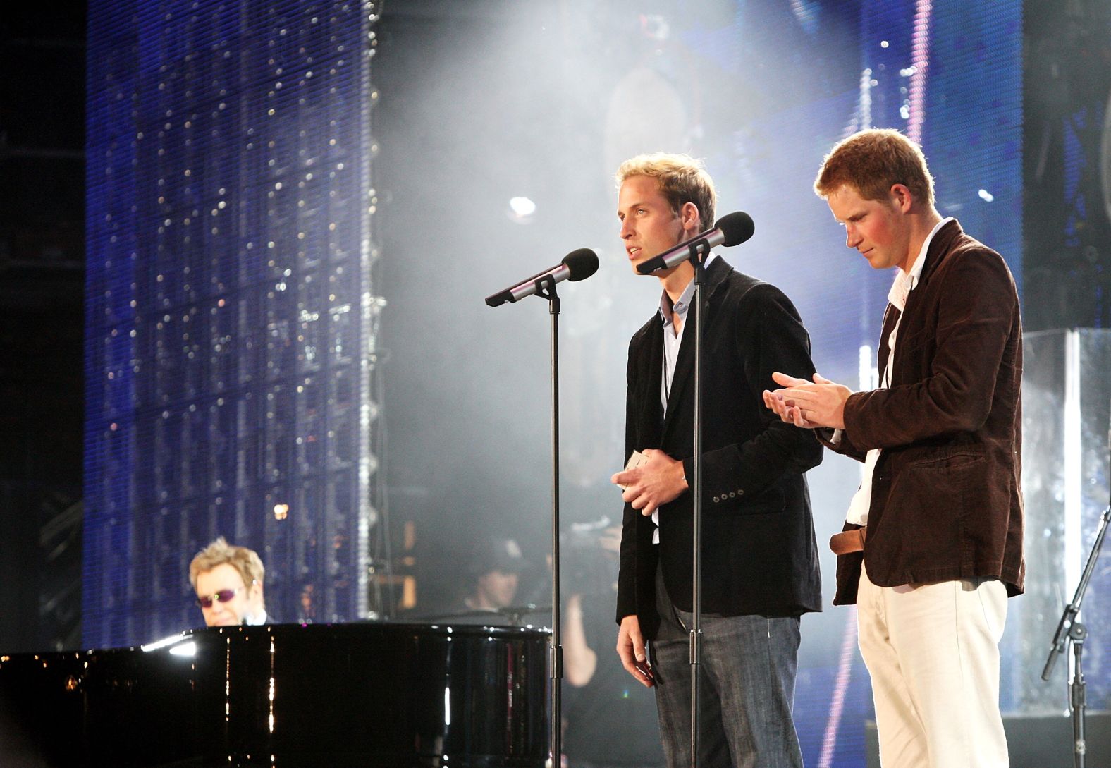 Prince William and Prince Harry speak on stage with Elton John, far left, during a concert they put on to celebrate Princess Diana in 2007. The event fell on what would have been their mother's 46th birthday.