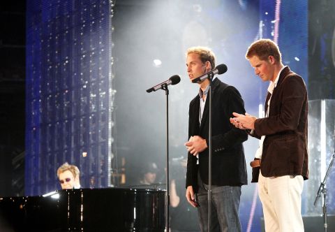 Prince William and Prince Harry speak on stage with Sir Elton John, far left, during a concert they put on to celebrate Princess Diana on July 1, 2007. The event fell on what would have been their mother's 46th birthday and marked 10 years since her death.
