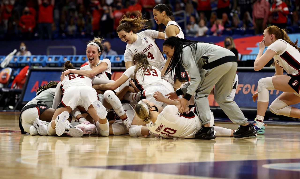 Stanford players celebrate after the final buzzer sounded in Sunday's championship game with Arizona. The Cardinal won 54-53 for the third title in school history.