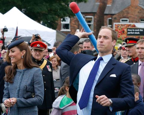 Prince William throws a foam javelin as his wife, now the Duchess of Cambridge, stands at his side during a visit to Nottingham, England, on June 13, 2012. The couple were in the city as part of Queen Elizabeth II's diamond jubilee tour, marking the 60th anniversary of her accession to the throne.