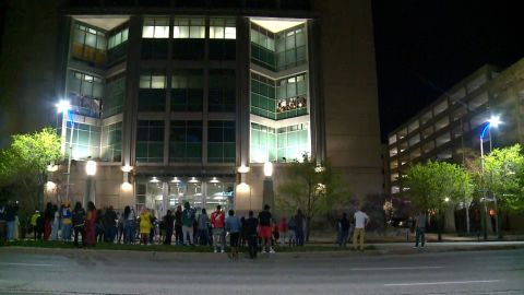 A crowd gathers on the street outside the St. Louis Justice Center on Sunday night. 