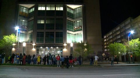 A crowd gathers on the street outside the St. Louis Justice Center on Sunday night.