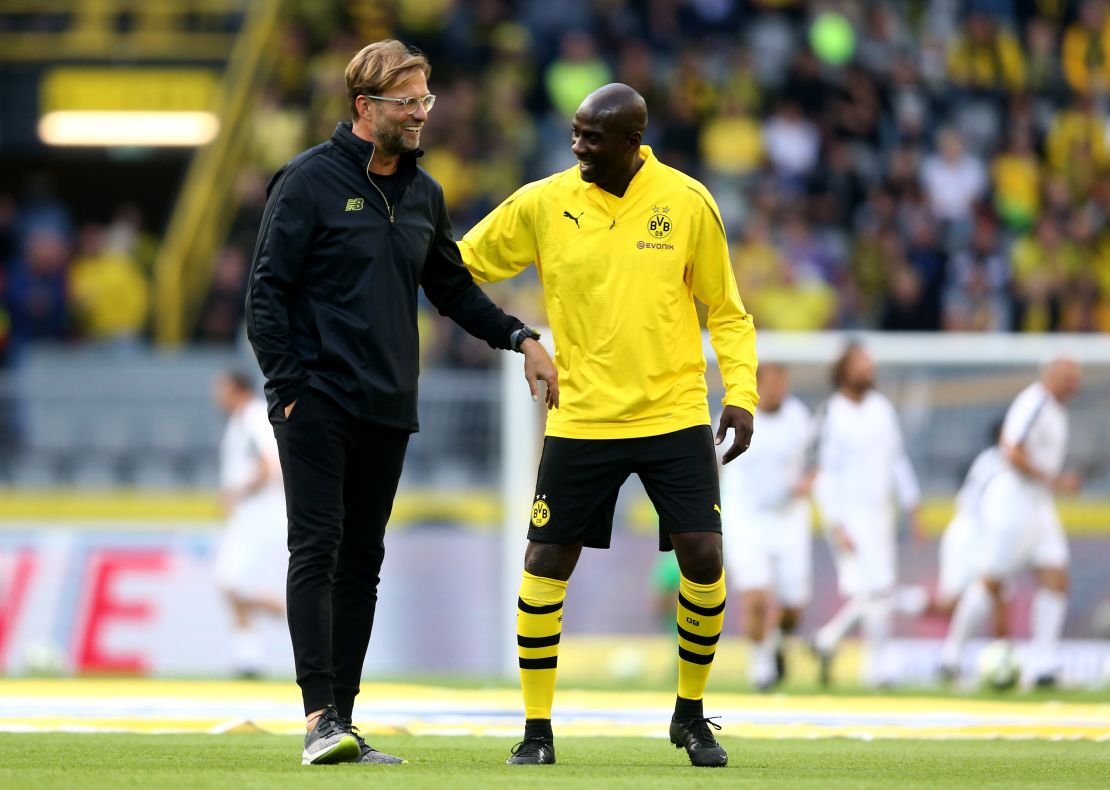 Otto Addo speaks with Borussia Dortmund's former coach Jurgen Klopp.
