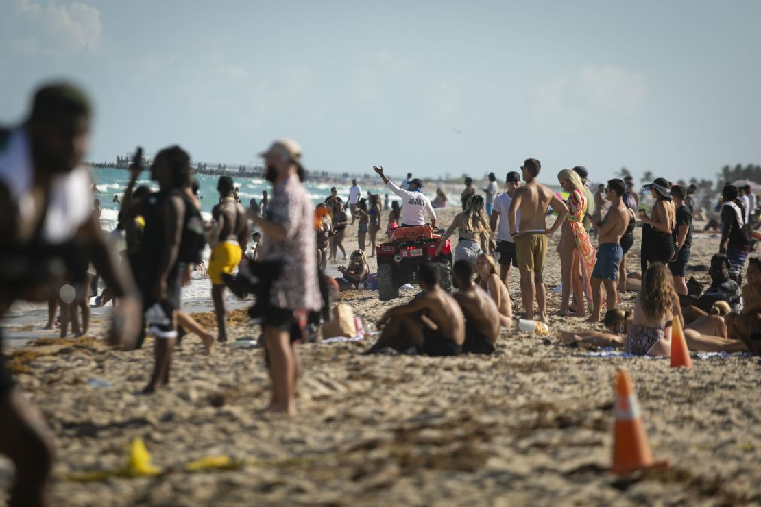 A lifeguard calls to swimmers in Miami Beach, Florida, on March 27.
