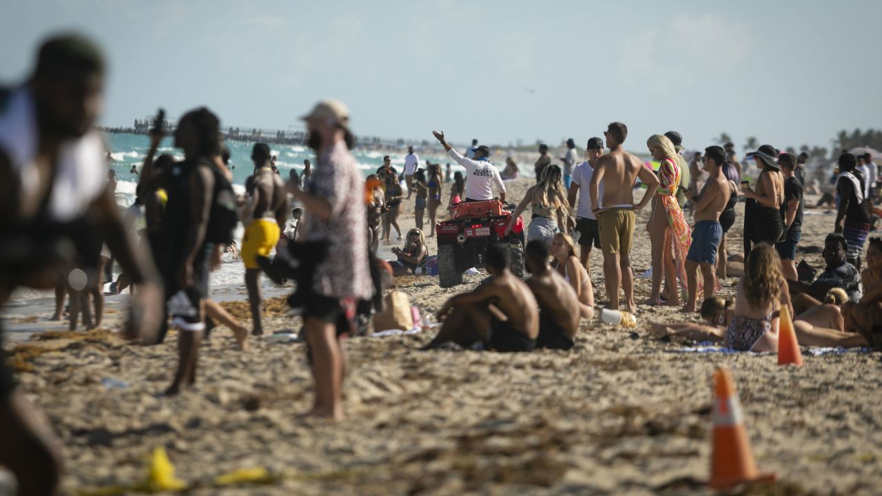 A lifeguard calls to swimmers in Miami Beach, Florida, on March 27.