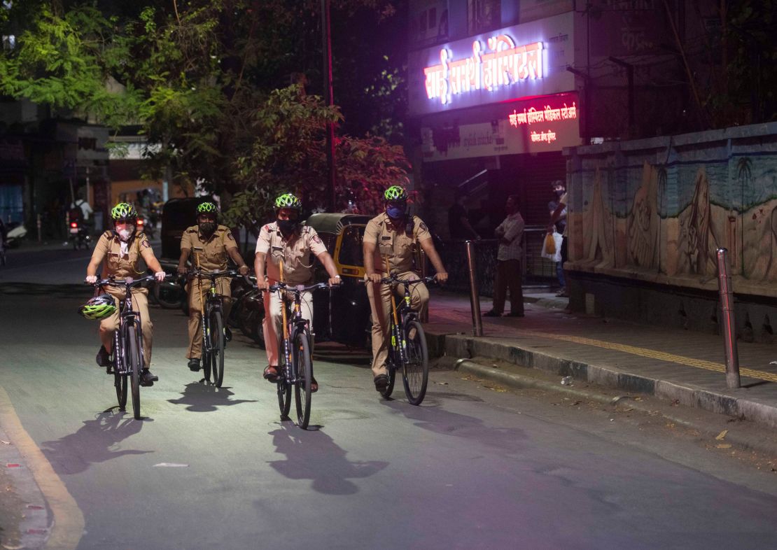 Police personnel patrol Pune, India, on April 3, as new evening curfews go into effect. 