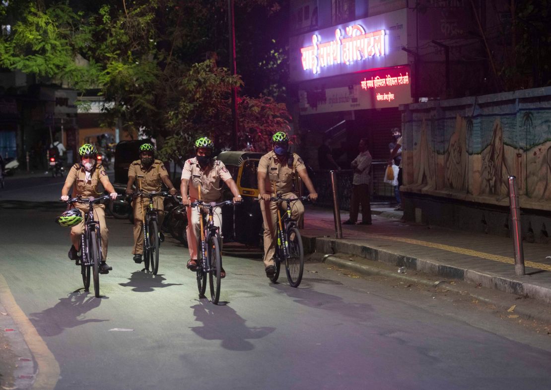 Police personnel patrol Pune, India, on April 3, as new evening curfews go into effect.