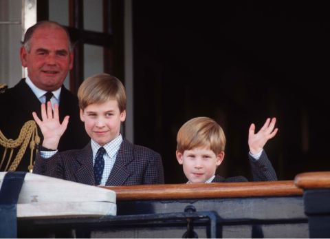 Prince William and Prince Harry wave from the deck of the Royal Yacht Britannia in 1991.