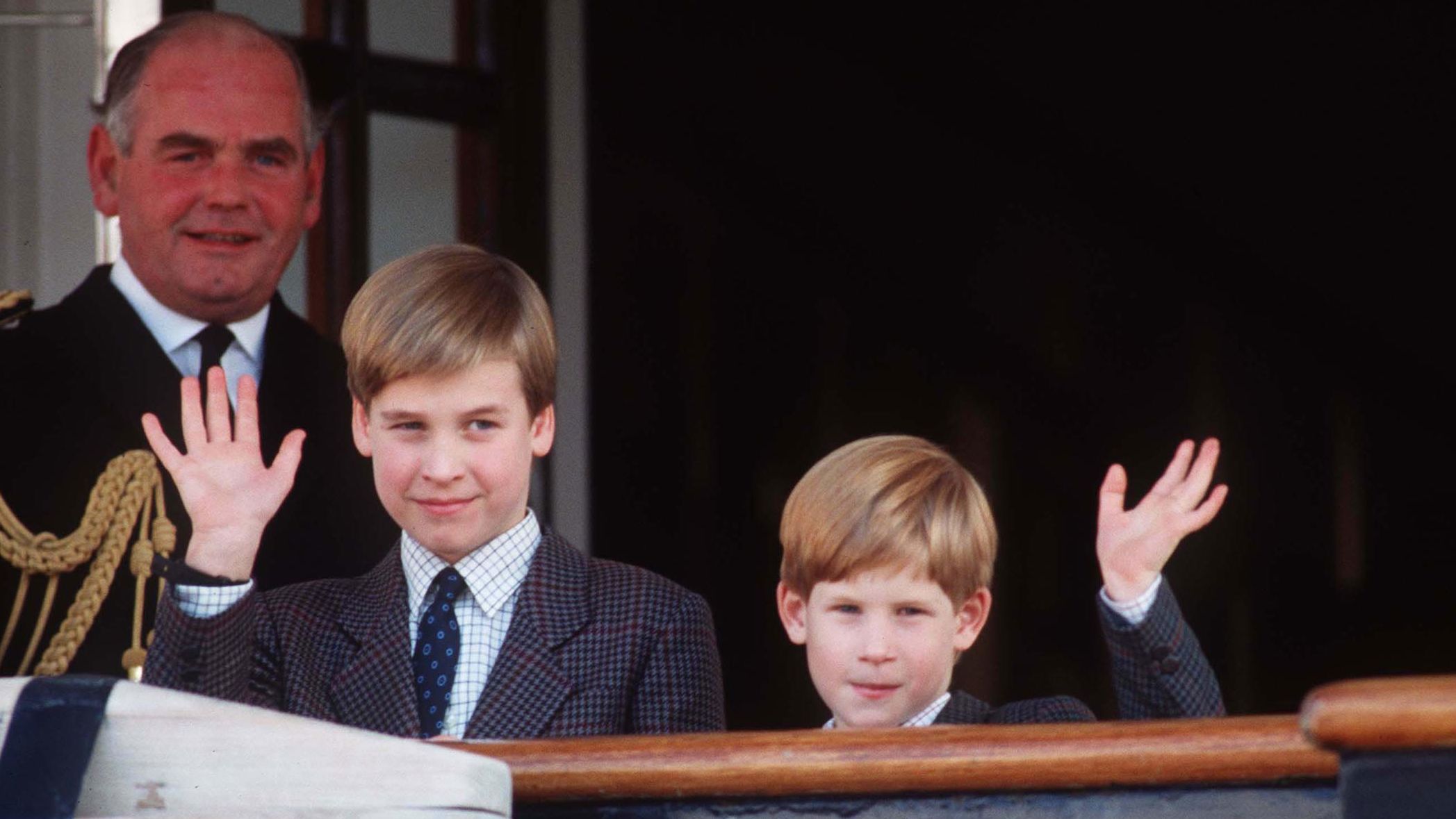 William and Harry wave from the deck of the Royal Yacht Britannia in 1991.