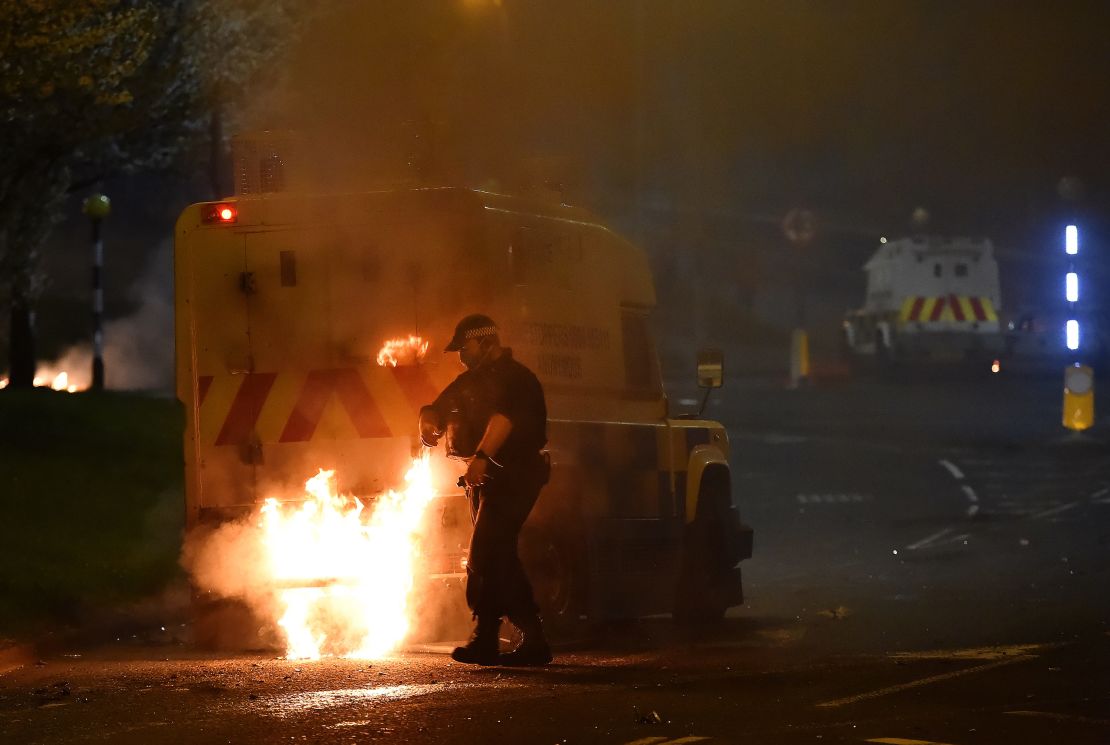 Police attend to a scene at Cloughfern as loyalist protesters hijack and burn vehicles on Saturday. 