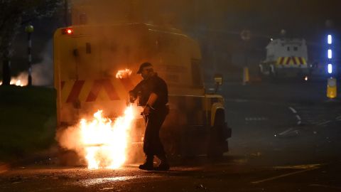 Police attend to a scene at Cloughfern as loyalist protesters hijack and burn vehicles on Saturday. 
